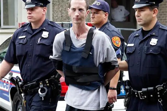 David Laffer being escorted by police in June